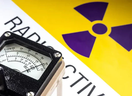 Radiation Detector laying on a Radiation Sign