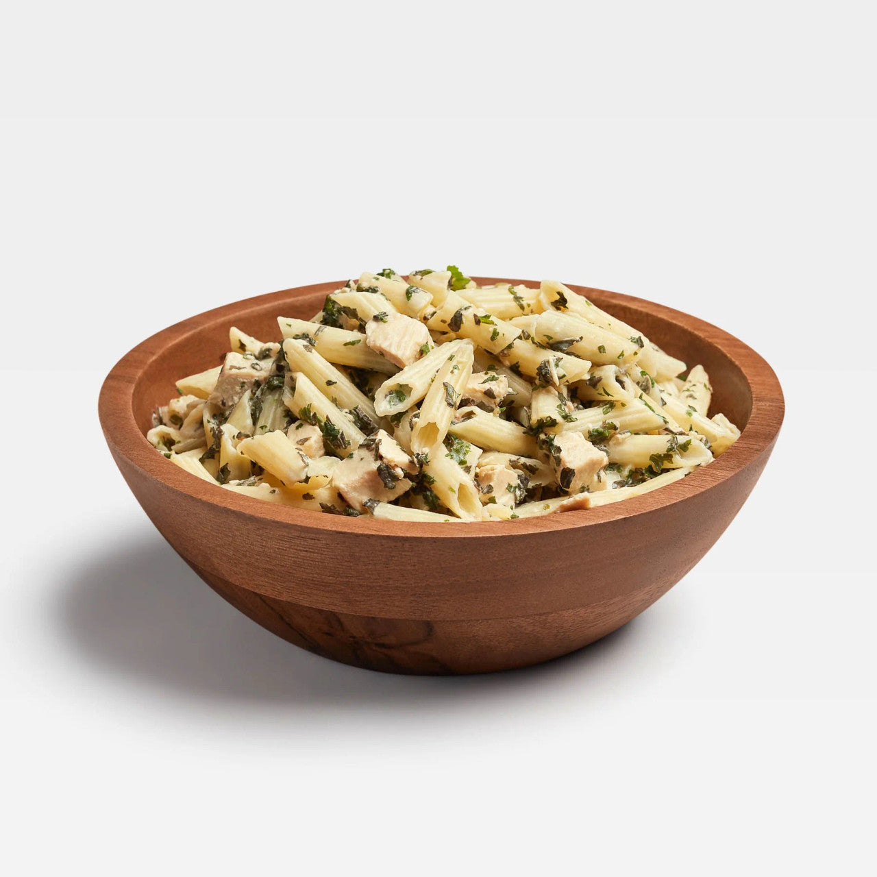 prepared Backpacker's Pantry Freeze Dried Pesto Pasta with Chicken in a wooden bowl