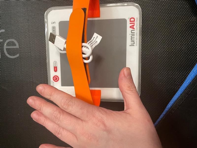 Compact LuminAID SURVIVOR in off-grid campsite setting