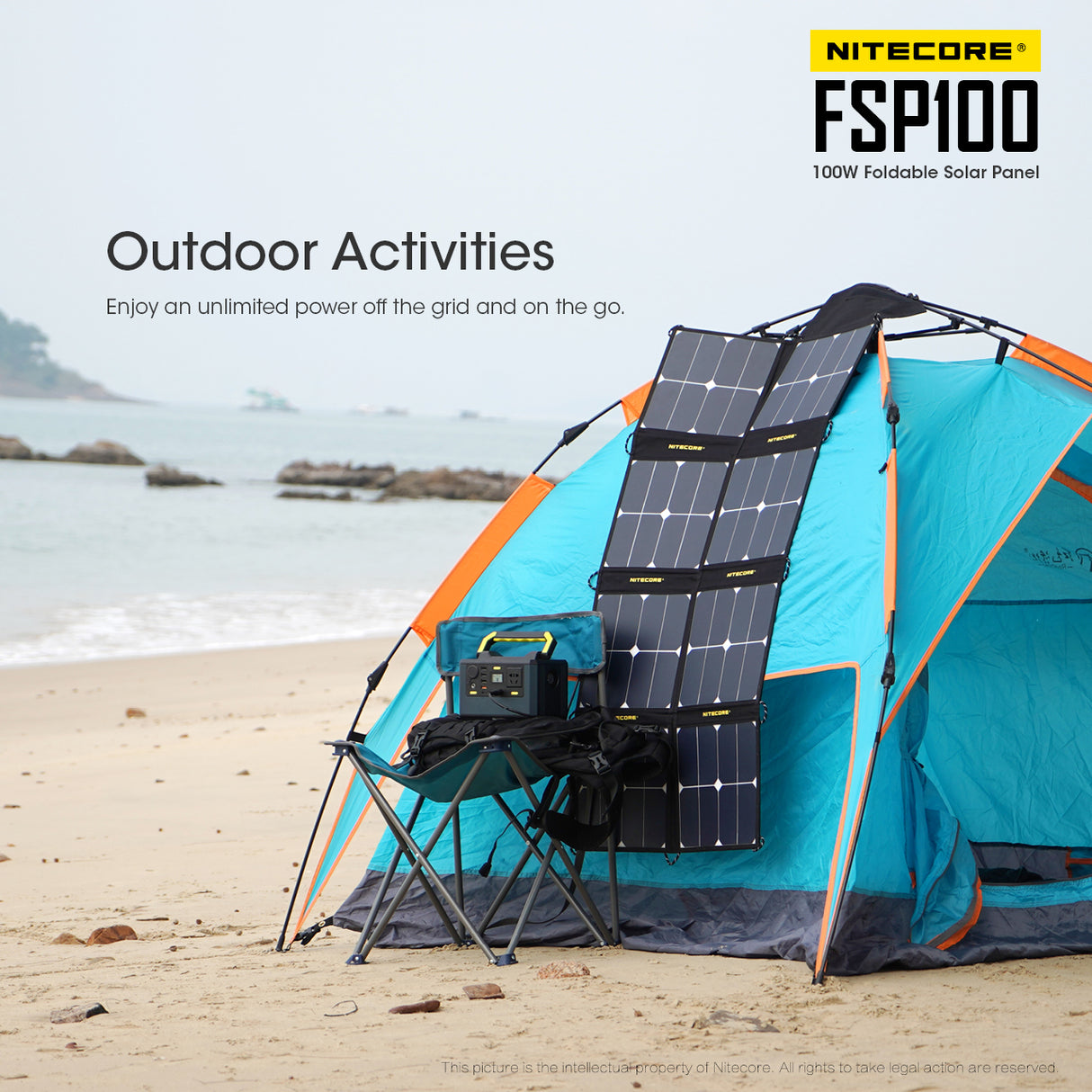 A Nitecore FSP100 100 Watt foldable solar panel laid on a blue tent on a beach charging a power bank on a camping chair via usb. The ocean tide rolls in the background.
