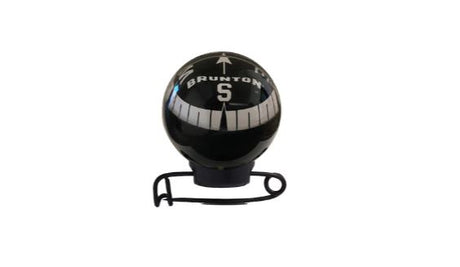 Brunton Mini Globe Compass attached on a pin in black with a reflective clear bulb.