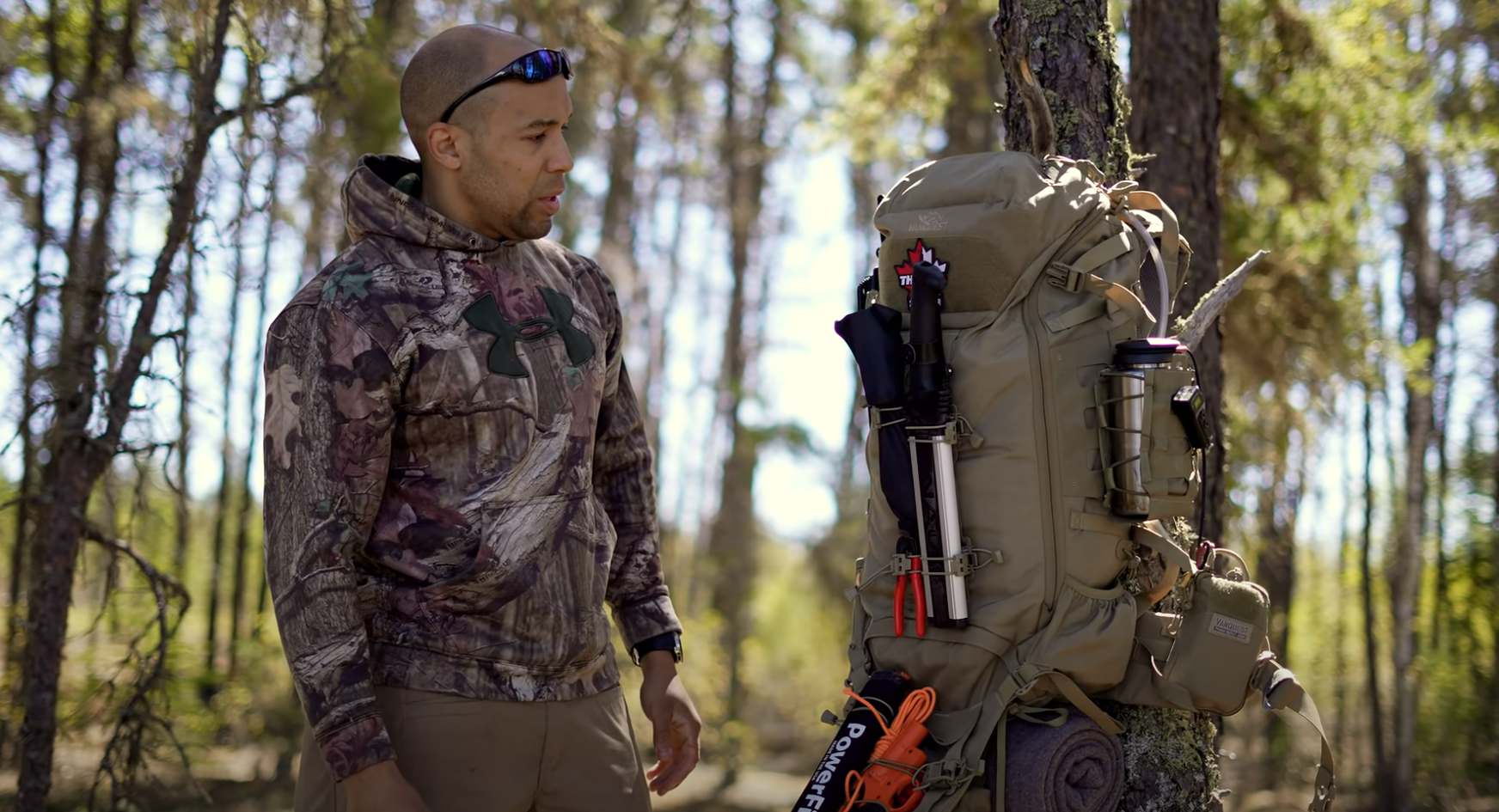 backpack used as a bug out bag hung from a tree