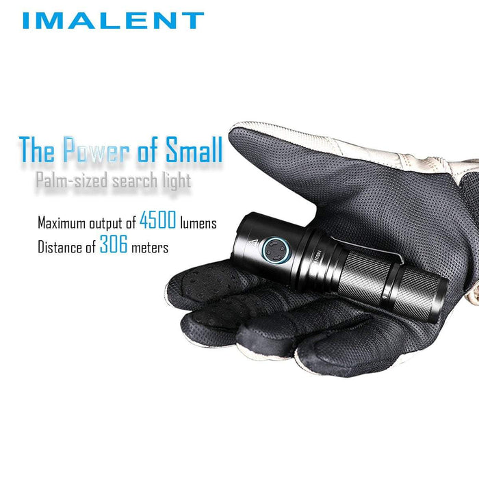 A person wearing a black glove holding the DM70 flashlight in the palm of their hand.