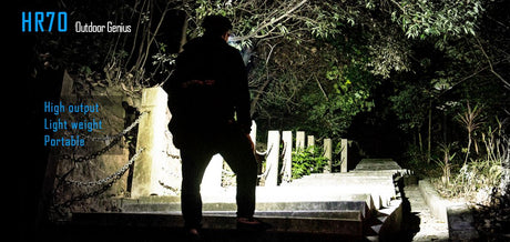 A person wearing a HR70 headlamp walking up a flight of stairs at night.