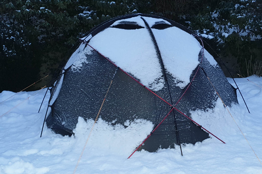 Snow covering the norTent Gamme 4 person tent in the backwoods.