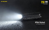 Nitecore p18 ip56 rated with 1m impact resistance. The flashlight is shown on a wet sufrace being rained on.