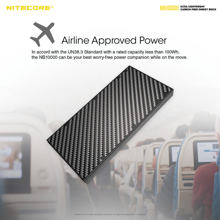 Airline approved power bank, the carbon fibre nitecore Nb10000. In the background people are watching a movie on a flight.