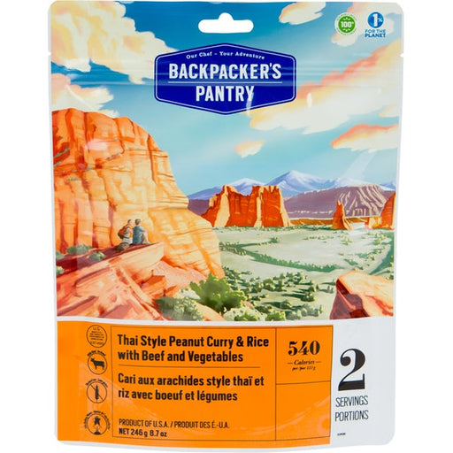 Front cover of the Backpackers Pantry: Thai Peanut Curry and Rice with Beef. On the package is a drawing of a couple sitting down side by side after a hike, overlooking a canyon valley with large mountains making up the horizon.