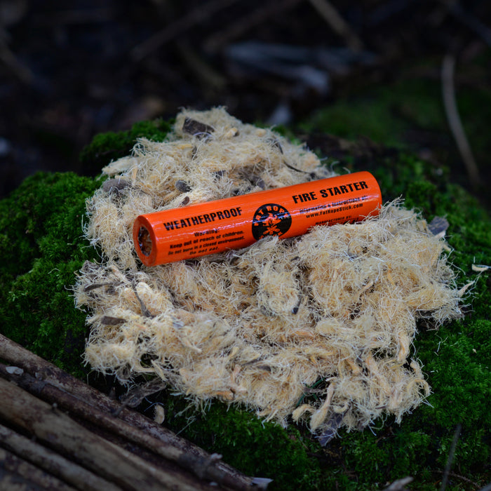 A Fat Rope Stick laid on the cotton fire starting threads on fresh green moss.