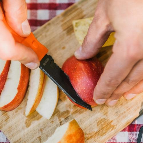 Slicing apples on a cutting board with the Gear Aid Buri Adventure Knife.