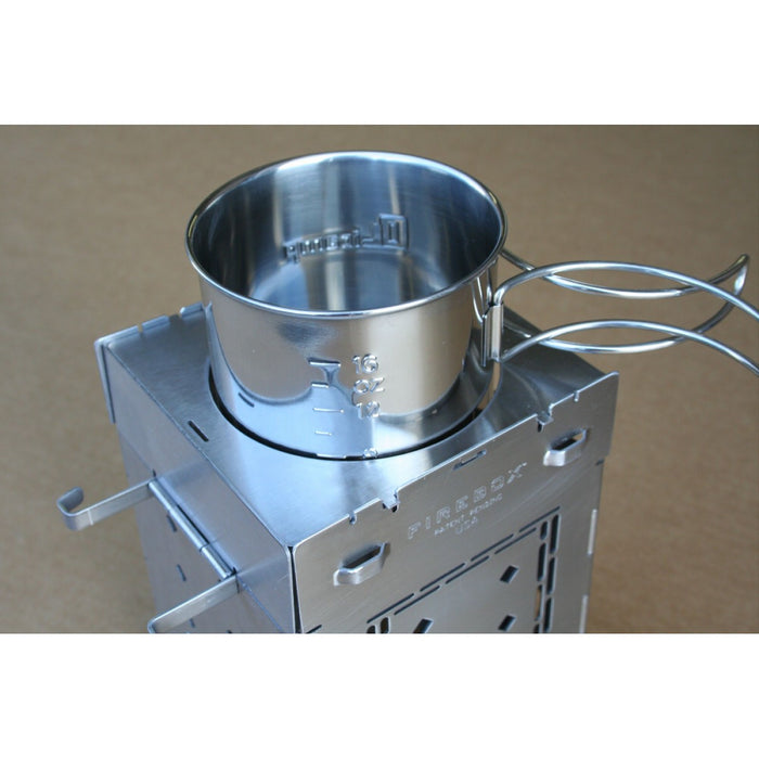 5 inch Boil plate cover clipped into the Firebox camp stove with a portable cooking and water boiling pot.