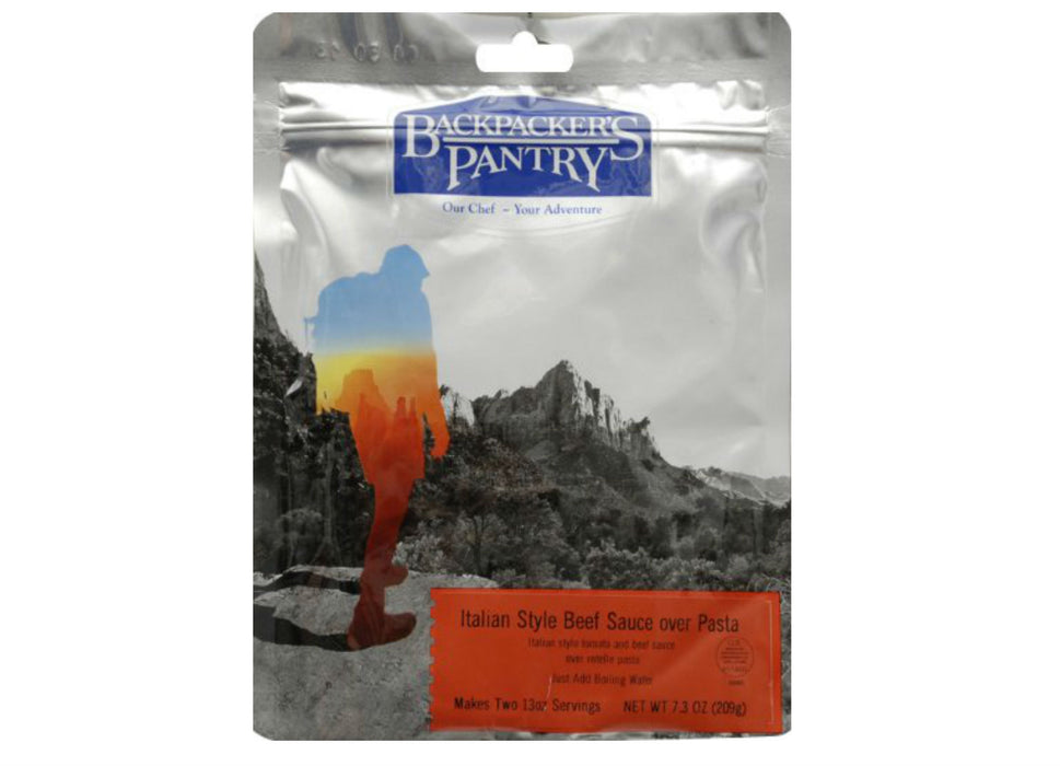 Packet of 'Backpackers Pantry- Italian Style Beef Sauce Over Pasta' with a hiker site seeing over a canyon valley.