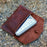 Brown stitched leather case for the Firebox Nano kit on a flat land outdoors in the fall.