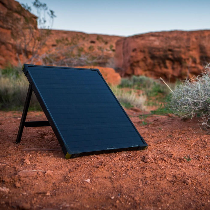 Boulder 50 Solar panel set up outside on red canyon terrain with dessert vegetatin surrounding it at dawn.