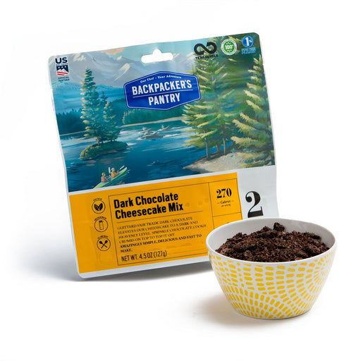 Backpackers Pantry: Dark Chocolate Cheesecake Mix package beside yellow spotted bowl of the prepared dessert.