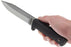 Person holding a Cold Steel Survival and Rescue knife and pointing it outward. The 'SRK' logo is printed on the blade and the finger guard is also shown on the knife handle.