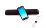 A black smart phone device being charged by a solarpower strip via white usb cable.