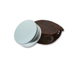 Hultafors Axe Grinding Stone taken out of it's leather case showcasing it's sandwich like design, which covers the Axe blade.