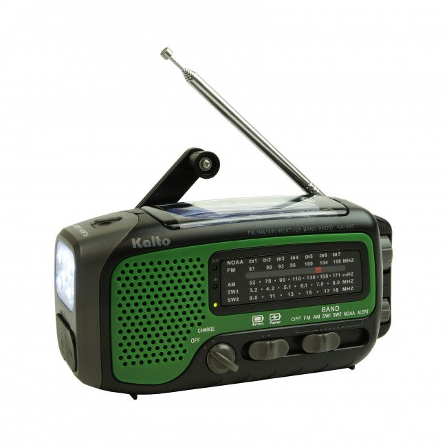 Kaito Voyager Trek KA 350 handheld radio with hand crank for power. In dark green, black, with grey buttons and dials.