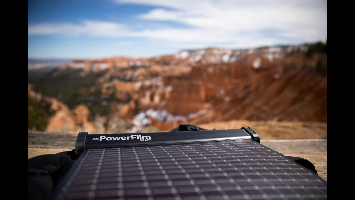 Lightsaver Max Solar Battery Powerfilm rested outside infront of a red canyon. 