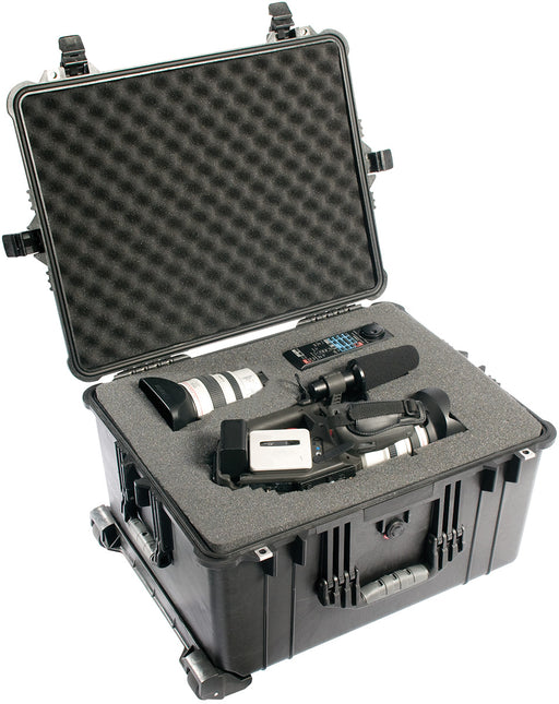 A video camera, video camera lens and a remote placed into the inside foam of a Pelican 1620 Protector case in black.