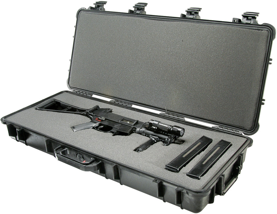 An UMP-45 semi automatic sub-machine gun with tactical flashlight and two extended magazines placed securely in the foam inside of the pelican 1700 Rifle Case.